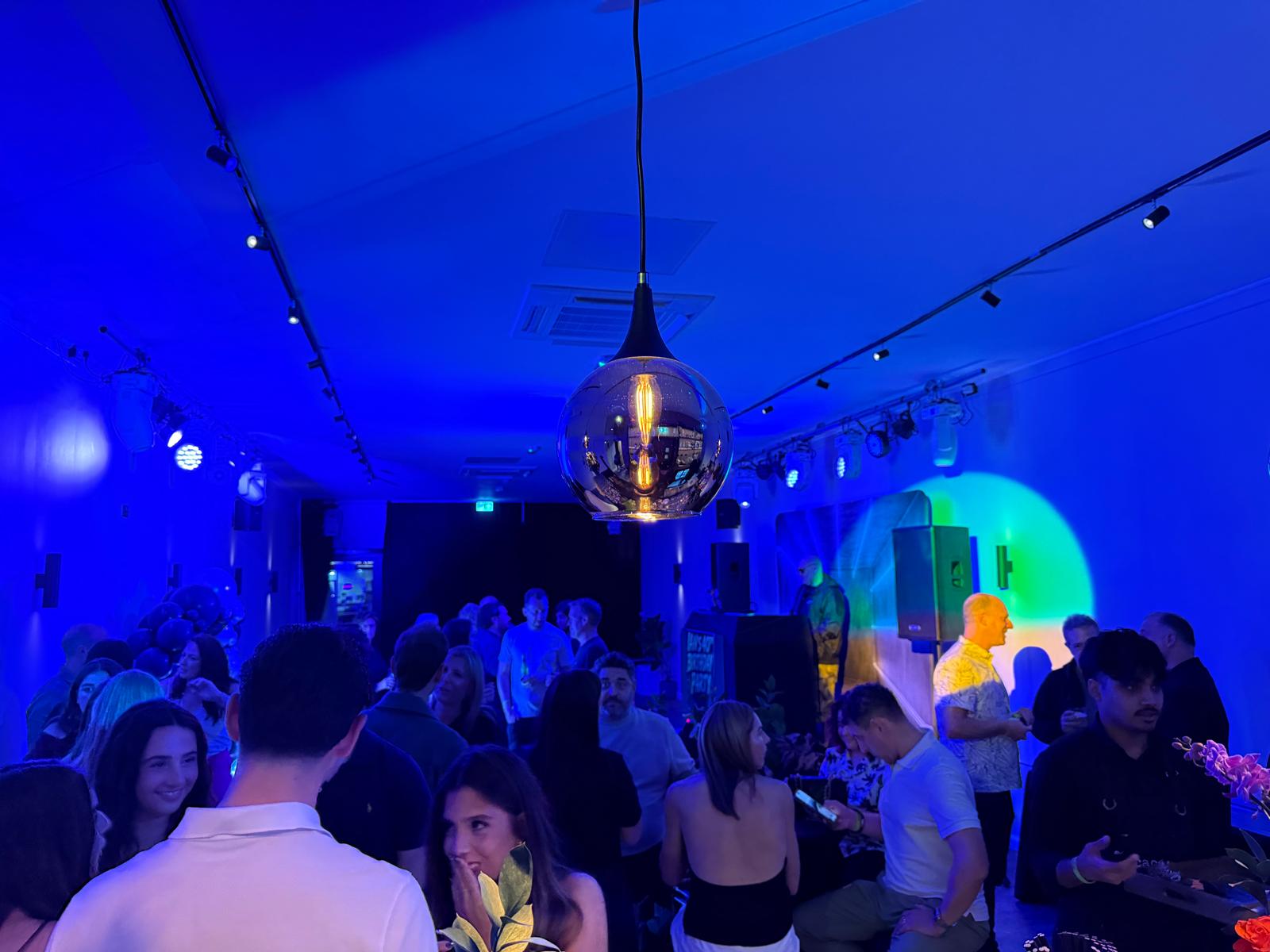 Guests gathering at No15 beneath blue evening lighting